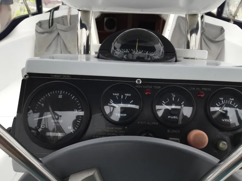 Control panel of a 2008 Catalina 320 MkII sailboat with gauges and compass.