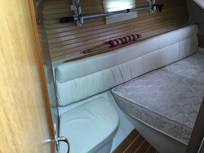 Interior cabin of 2008 Catalina 320 MkII sailboat with cushioned seating and wooden accents.