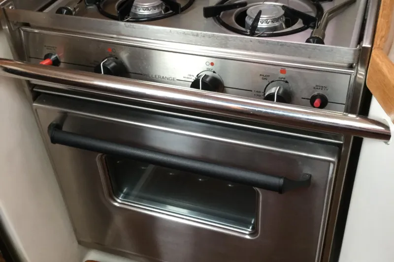 Stainless steel stove and oven in a 2008 Catalina 320 MkII yacht kitchen.