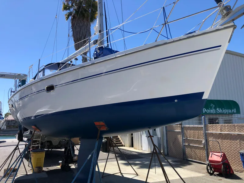 2008 Catalina 320 MkII sailboat on stands at a shipyard.