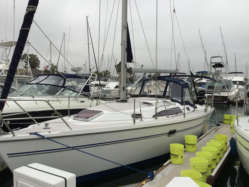2008 Catalina 320 MkII sailboat docked at marina with yellow buckets on pier.