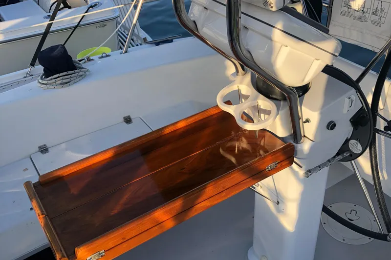 Cockpit of 2008 Catalina 320 MkII sailboat with wooden table and steering wheel.