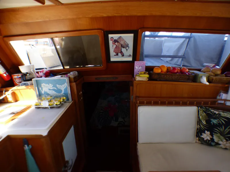 Interior of 1984 Spindrift 39 ft. Aft Cabin Twin Diesel with cozy seating and fruit display.