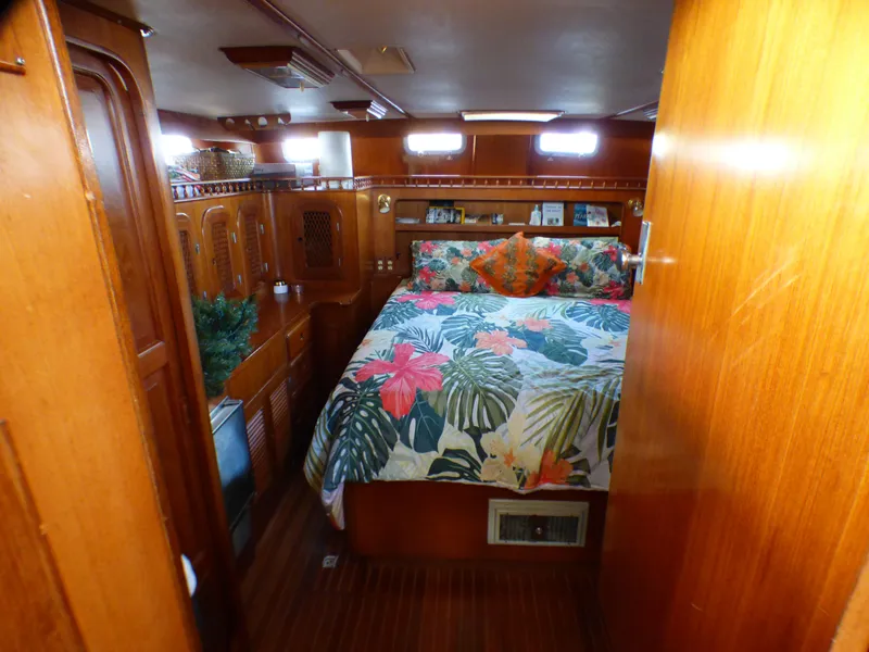 1984 Spindrift 39 ft. aft cabin with floral bedding and wooden interior.