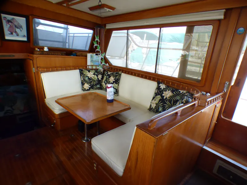 1984 Spindrift 39 ft. aft cabin interior with wooden dining area and cushioned seating.