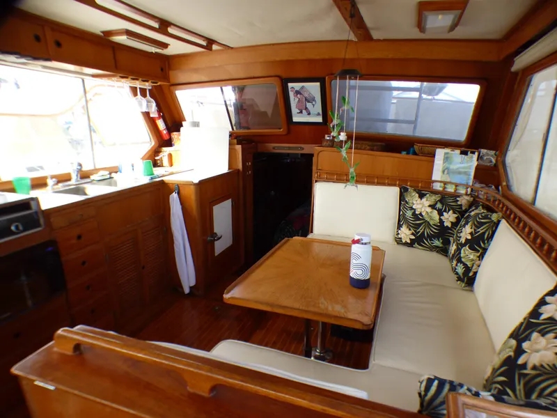 Interior of 1984 Spindrift 39 ft. Aft Cabin Twin Diesel yacht with cozy seating and kitchen.