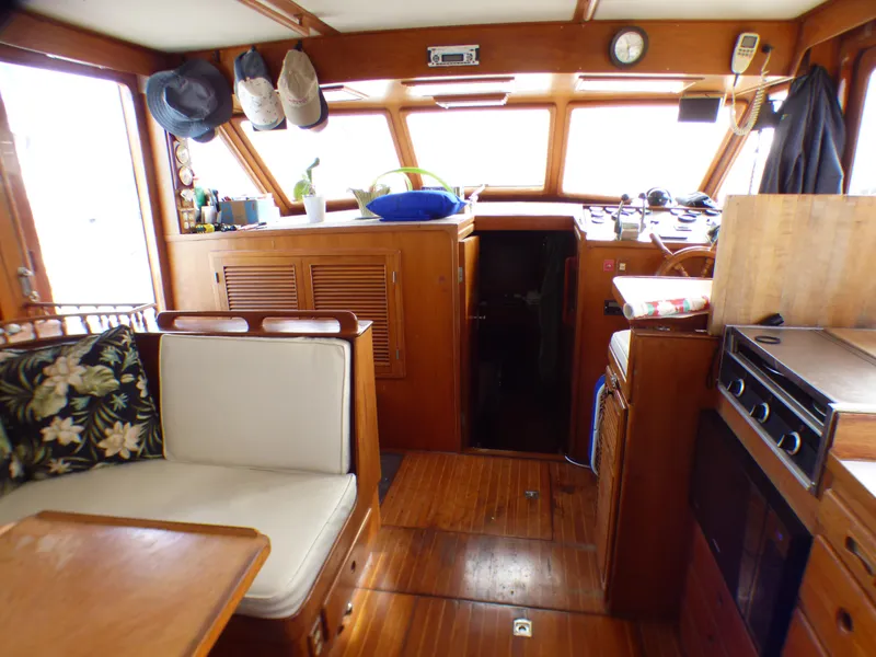 Interior of 1984 Spindrift 39 ft. Aft Cabin Twin Diesel yacht, featuring cozy seating and wooden finishes.