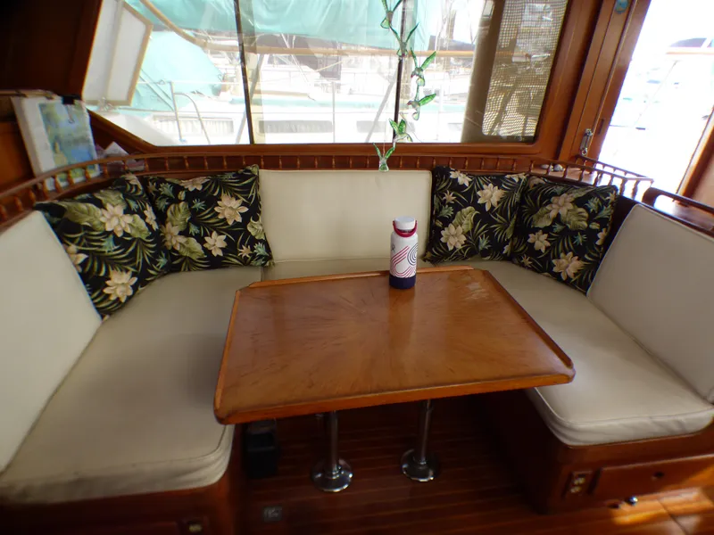 1984 Spindrift 39 ft. aft cabin interior with cushioned seating and wooden table.