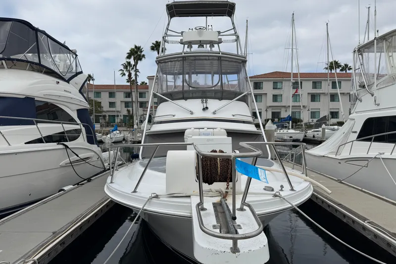 1993 Blackfin Sportfisher boat docked at marina with surrounding yachts.
