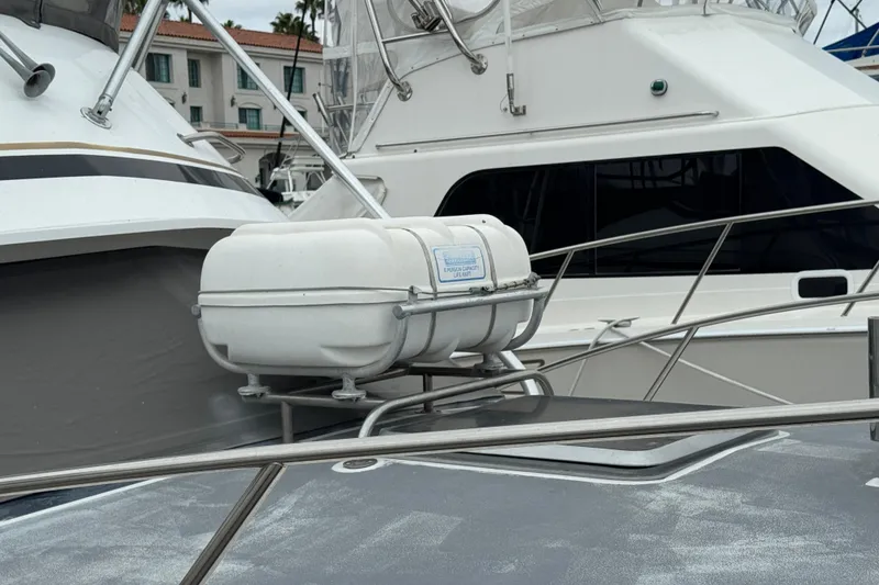 1993 Blackfin Sportfisher boat with life raft on deck, docked at marina.