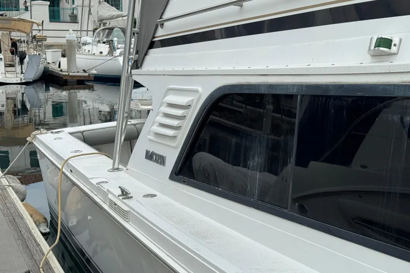 1993 Blackfin Sportfisher boat docked at a marina, side view.