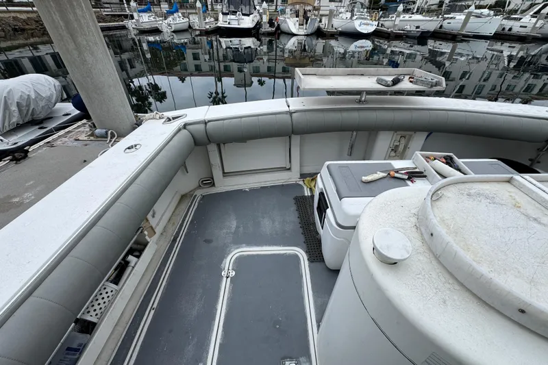 1993 Blackfin Sportfisher boat deck with fishing gear, docked at marina.