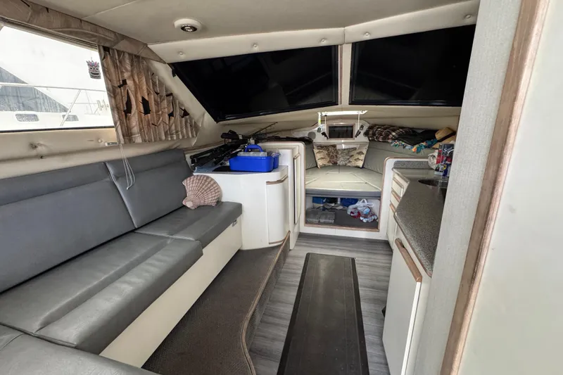 Interior of a 1993 Blackfin Sportfisher boat with seating and storage areas.
