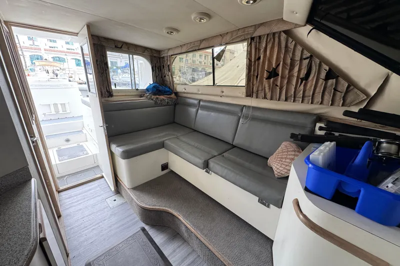 Interior of a 1993 Blackfin Sportfisher boat with gray seating and nautical decor.