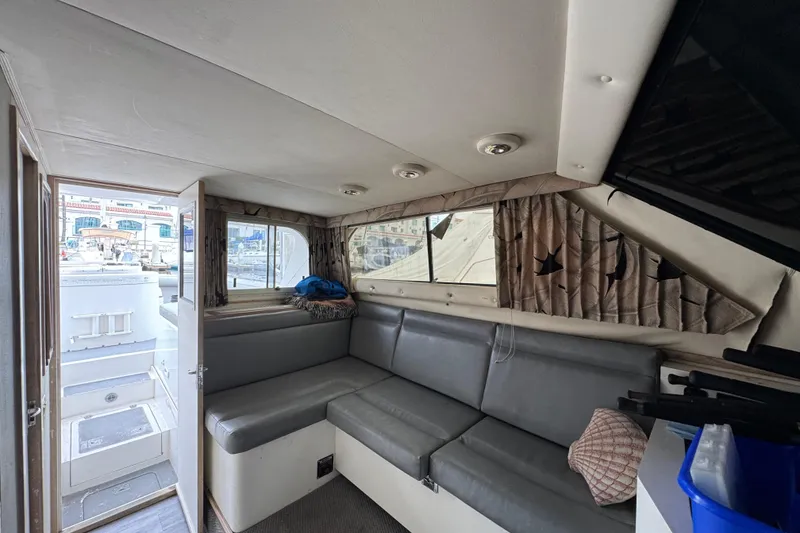 Interior of 1993 Blackfin Sportfisher boat with gray seating and nautical decor.