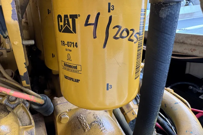 Caterpillar oil filter on 1993 Blackfin Sportfisher engine, marked "4/2025" for maintenance.
