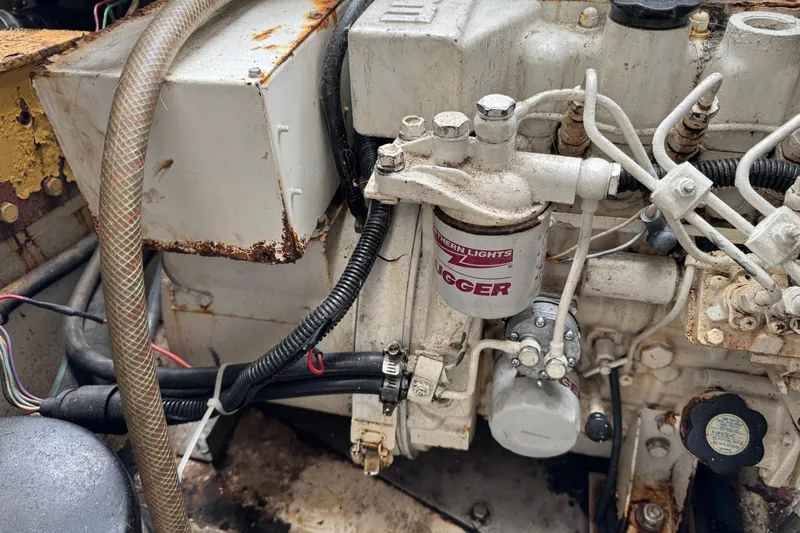 Engine compartment of a 1993 Blackfin Sportfisher boat, showing mechanical components and wiring.