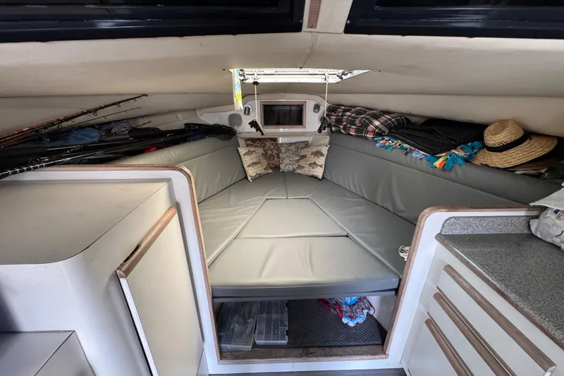 1993 Blackfin Sportfisher cabin interior with fishing rods and cozy seating area.