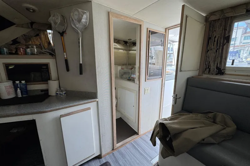 Interior of a 1993 Blackfin Sportfisher boat with fishing nets and seating area.