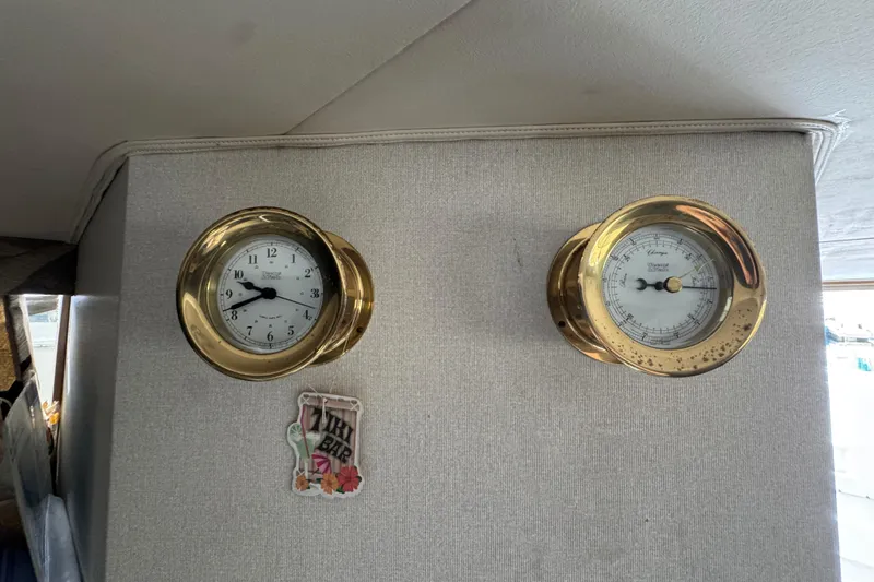 Brass clock and barometer on 1993 Blackfin Sportfisher boat interior wall.