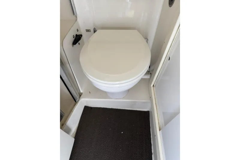 1993 Blackfin Sportfisher boat bathroom with white toilet and compact design.