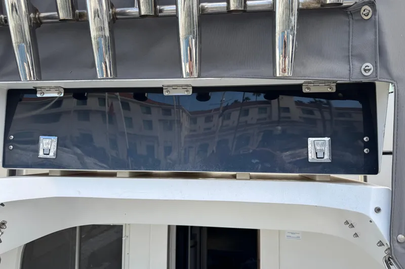 1993 Blackfin Sportfisher boat detail with chrome rod holders and storage compartment.