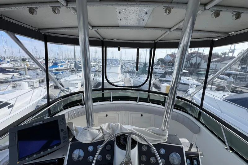 1993 Blackfin Sportfisher boat cockpit view in marina, surrounded by yachts and sailboats.