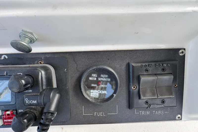 1993 Blackfin Sportfisher dashboard with fuel filter and trim tab controls.