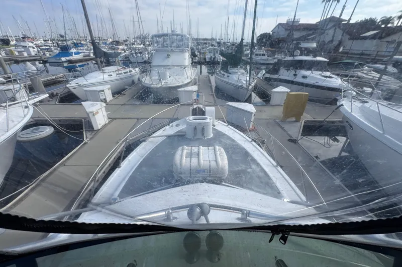 1993 Blackfin Sportfisher docked in a crowded marina, surrounded by various boats.
