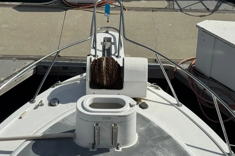 1993 Blackfin Sportfisher boat deck with anchor chain and railing at dock.