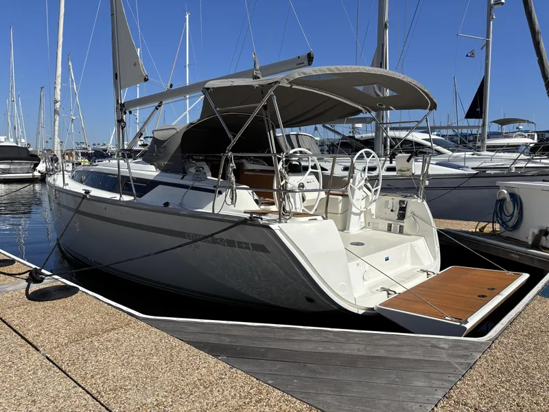 2020 Bavaria Cruiser 34 yacht docked at marina under clear blue sky.