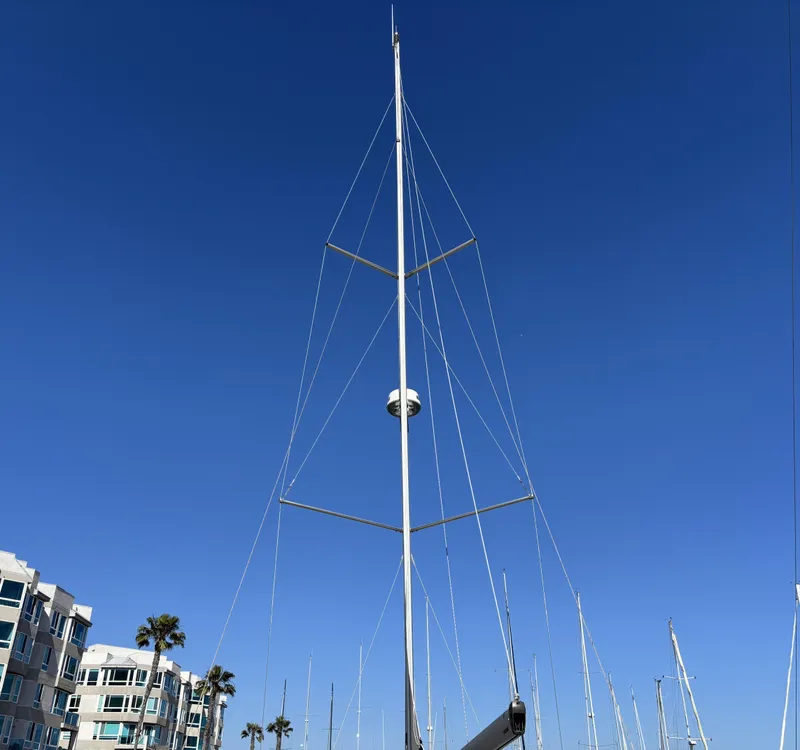 Tall mast of a 2020 Bavaria Cruiser 34 sailboat against a clear blue sky.