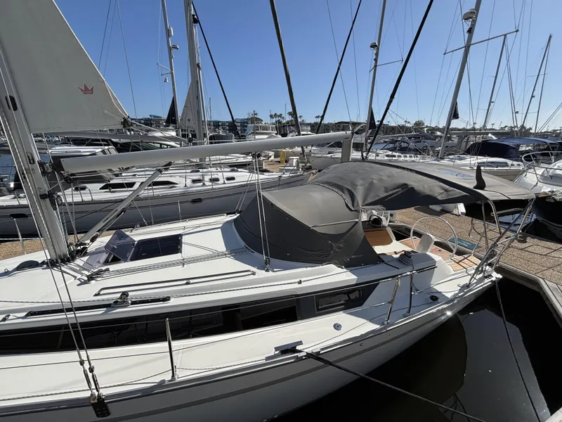 2020 Bavaria Cruiser 34 sailboat docked in a marina under clear blue skies.