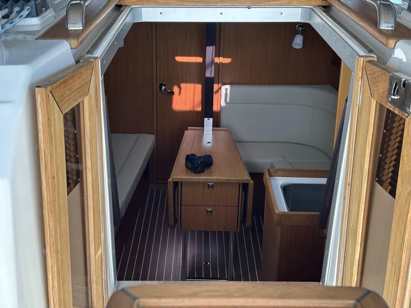 Interior of 2020 Bavaria Cruiser 34 yacht with wooden furnishings and seating area.