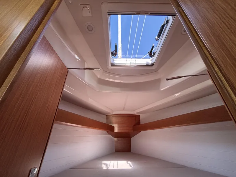 Interior cabin view of 2020 Bavaria Cruiser 34 yacht with skylight and wooden finish.