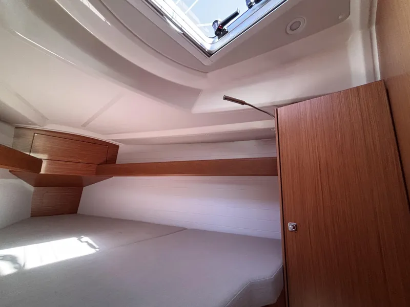 Interior cabin of 2020 Bavaria Cruiser 34 yacht with wooden finish and overhead hatch.