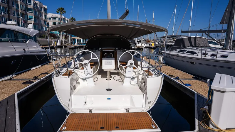 2020 Bavaria Cruiser 34 yacht docked at marina, featuring dual steering wheels.