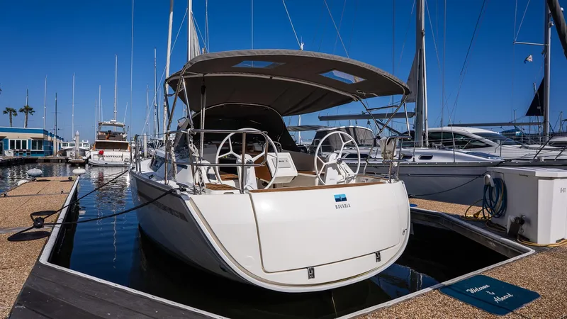 2020 Bavaria Cruiser 34 yacht docked at marina under clear blue sky.