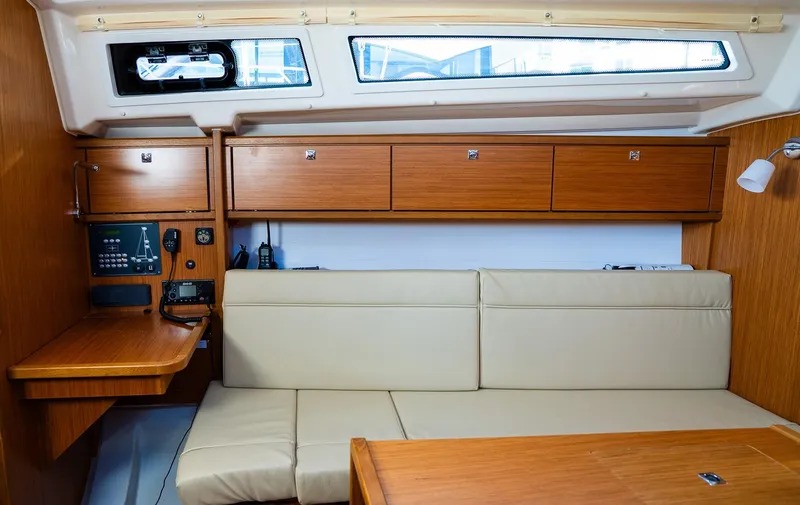 Interior of 2020 Bavaria Cruiser 34 yacht with beige seating and wooden cabinetry.