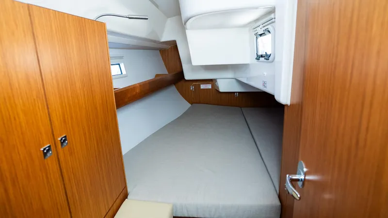 Cozy cabin interior of 2020 Bavaria Cruiser 34 yacht with wooden finish and comfortable bed.