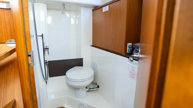 2020 Bavaria Cruiser 34 yacht bathroom with wooden cabinets and modern fixtures.
