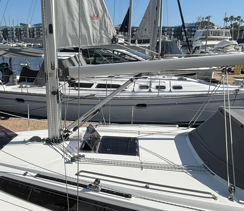 2020 Bavaria Cruiser 34 sailboat docked in a marina, surrounded by other boats.