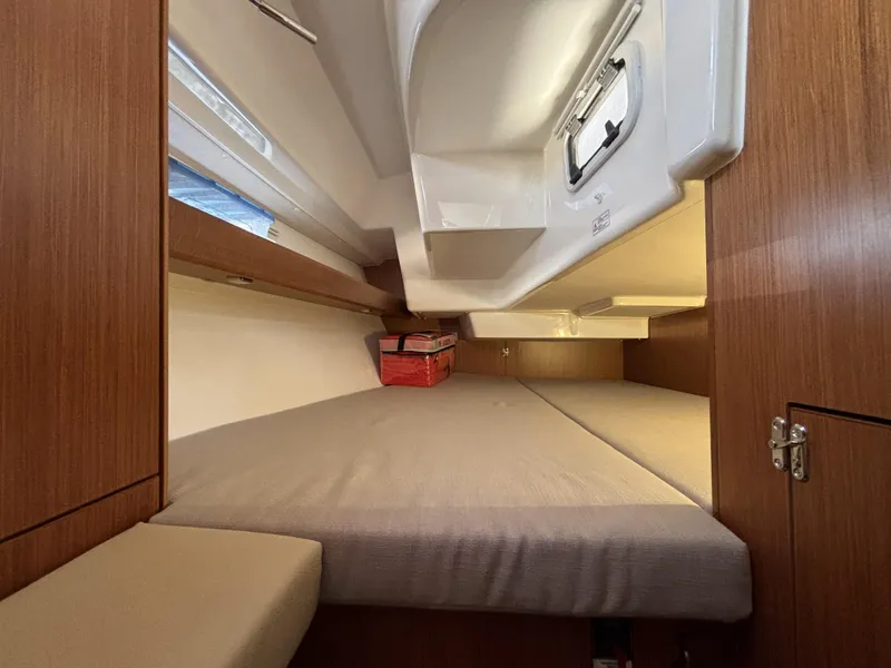 Cozy cabin interior of 2020 Bavaria Cruiser 34 sailboat with wooden finish and comfortable bedding.