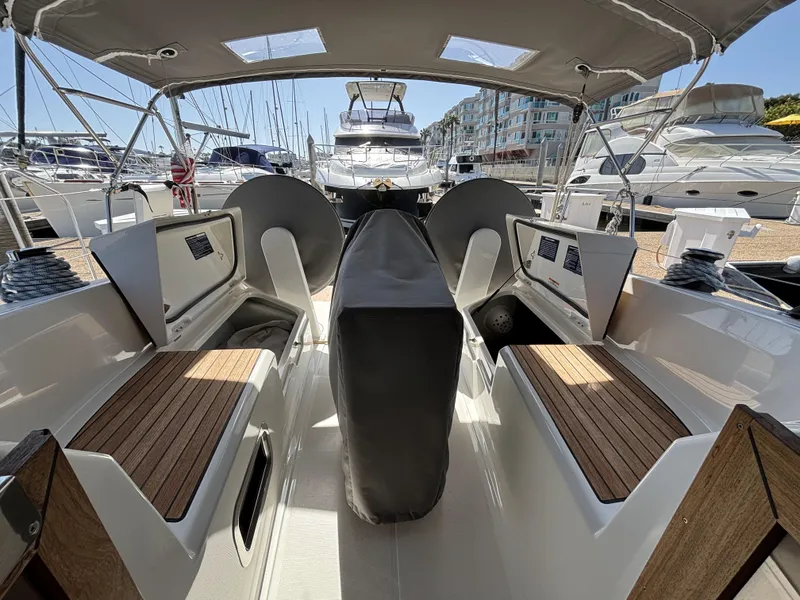 2020 Bavaria Cruiser 34 yacht interior with seating and covered helm, docked at marina.