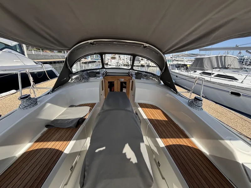 2020 Bavaria Cruiser 34 yacht interior with sleek design and wooden deck in a marina setting.