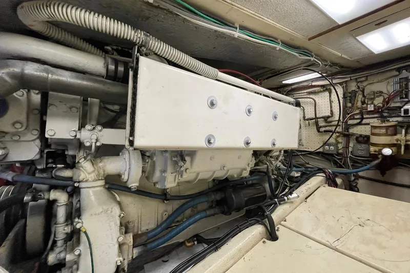Engine room of a 1975 Uniflite Sport Fisher 42, showcasing mechanical components and wiring.