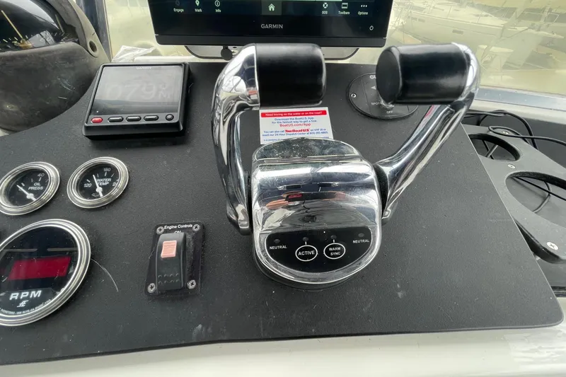 Control panel of a 1975 Uniflite Sport Fisher 42 with throttle and gauges.
