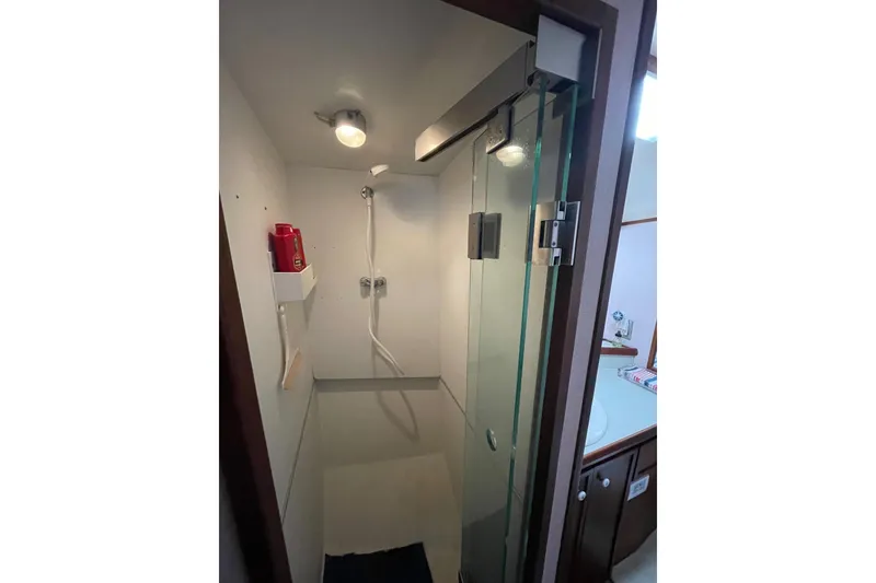 1975 Uniflite Sport Fisher 42 yacht shower with glass door and modern fixtures.