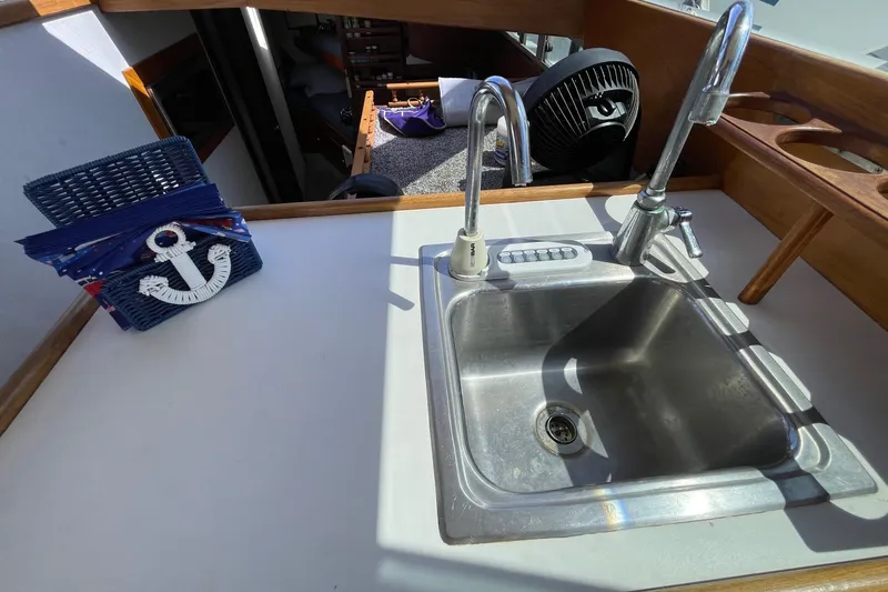 1975 Uniflite Sport Fisher 42 boat interior with sink and nautical decor.
