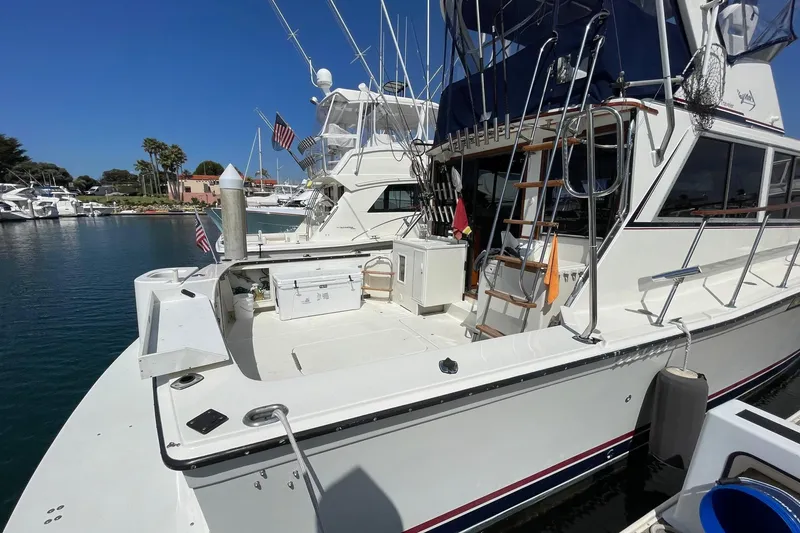 1975 Uniflite Sport Fisher 42 docked, featuring spacious deck and fishing equipment.